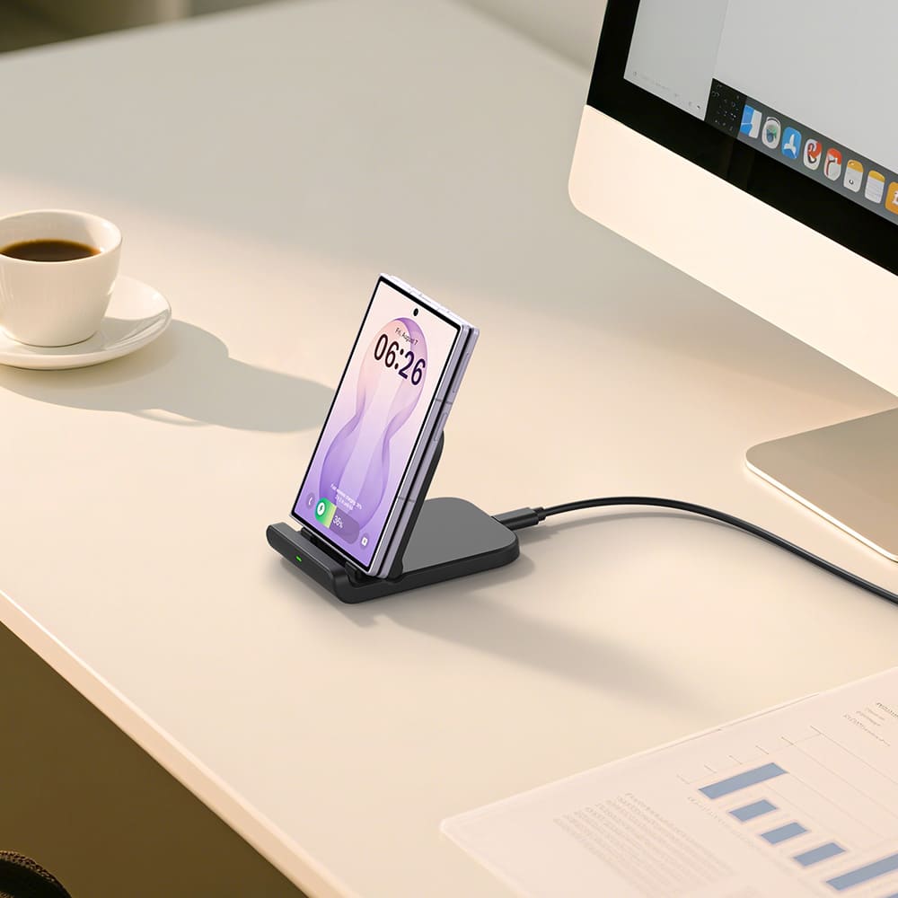 Black SwanScout 501S foldable stand charging a Galaxy Z Flod on a clean desk with coffee and computer
