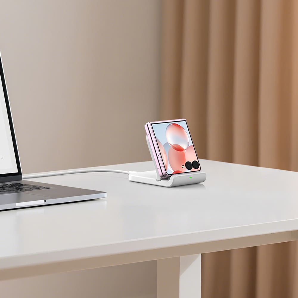 SwanScout 501S wireless stand charging a Galaxy Z Flip phone on a desk next to a laptop